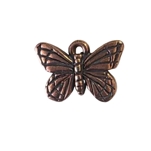 Bronze butterfly-shaped metal charm on a gray background