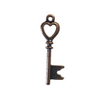 Bronze key pendant charm on a light gray background