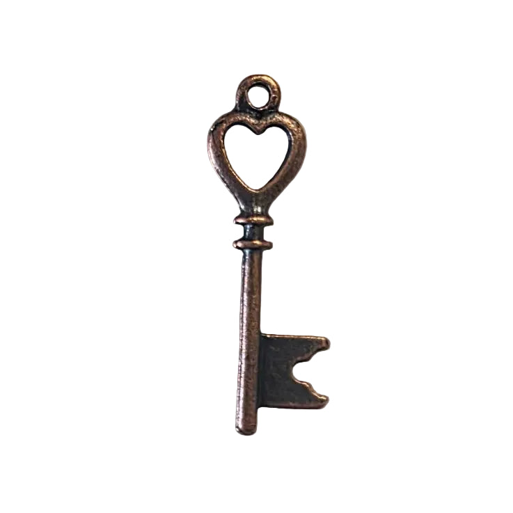 Bronze key pendant charm on a light gray background