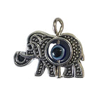 Silver elephant pendant with third eye on a gray background