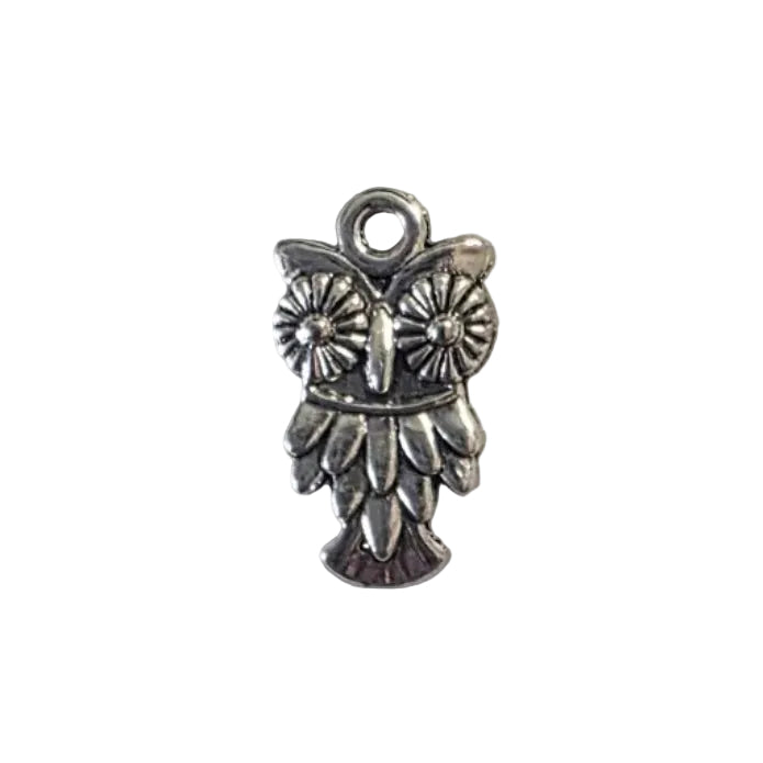 Silver charm of an owl with daisy eyes and feathered body on a light gray background