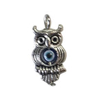 Silver owl with third eye shaped charm on a light gray background