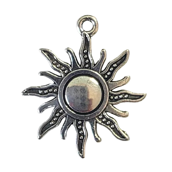 Silver sun-shaped pendant on a light gray background