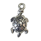 Silver turtle charm on a white background