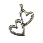 Silver pendant with two hearts on a light gray background