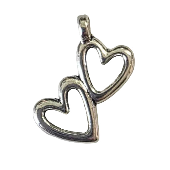 Silver pendant with two hearts on a light gray background